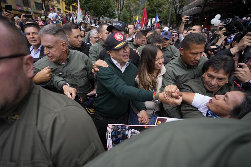 Colombian President Gustavo Petro greets supporters as he attends the International Workers' Day march in Bogota, Colombia, Wednesday, May 1, 2024. Colombia has become the latest Latin American country to announce it will break diplomatic relations with Israel over its military campaign in Gaza. (AP Photo/Fernando Vergara)