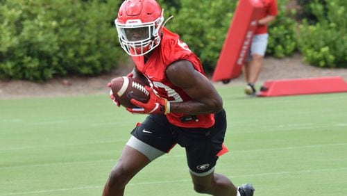 Georgia receiver George PIckens (83) hauls in a pass during one of the Bulldogs' early practices of the preseason. The 5-star signee from Hoover will wear the No. 1 during games this year.