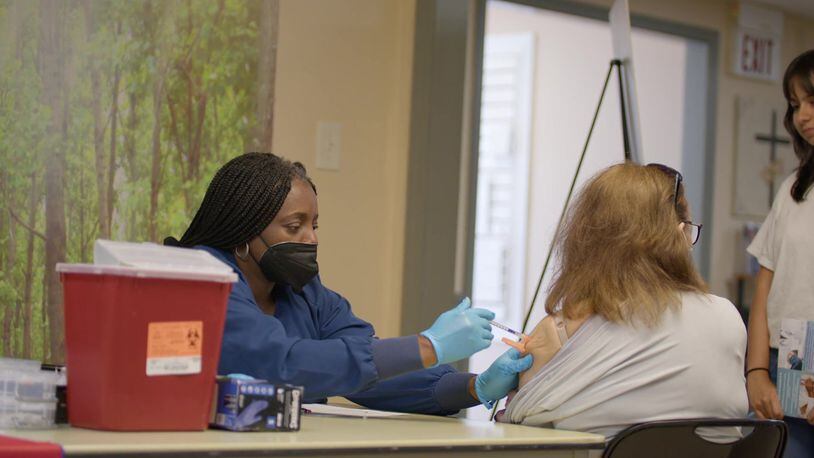 A patient gets a shot at a "pop-up doc" clinic meant to help workers who don't have insurance.