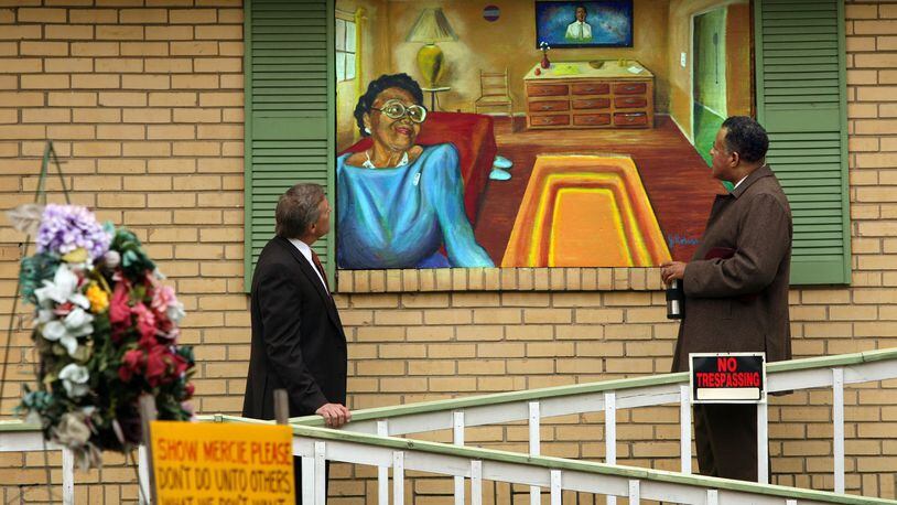 Gordon, left, and Motley admire a Janssen Robinson mural of Johnston painted on plywood over her boarded up home in the English Avenue community in 2008. CURTIS COMPTON / ccompton@ajc.com