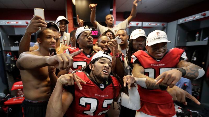  Atlanta Falcons players celebrate in the locker room after the NFL football NFC championship game against the Green Bay Packers Sunday, Jan. 22, 2017, in Atlanta. The Falcons won 44-21 to advance to Super Bowl LI. (David J. Phillip/AP)