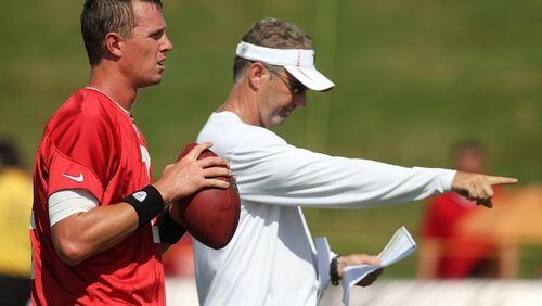 072712 FLOWERY BRANCH: Offensive coordinator Dirk Koetter calls a play with Matt Ryan approaching the line in Flowery Branch on Friday, July 27, 2012.      CURTIS COMPTON / CCOMPTON@AJC.COM