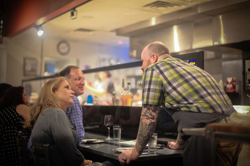 More interaction with guests was one of chef Kevin Gillespie's aims with Gunshow. Here, he visits with restaurant patrons. Courtesy of Gunshow