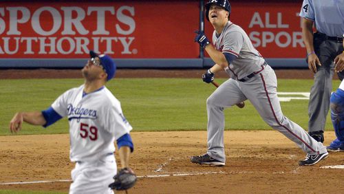 Atlanta Braves' Kris Medlen, right, hits a solo home run as Los Angeles Dodgers starting pitcher Stephen Fife looks on during the fifth inning of their baseball game, Saturday, June 8, 2013, in Los Angeles. (AP Photo/Mark J. Terrill)