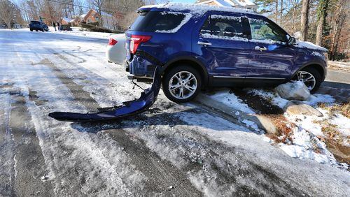 January 8, 2017, Canton: A wrecked Ford Explorer sits at the bottom of ice covered Timber Terrace Road in the Cherokee Falls Estates at the Lake subdivison off Sixes Road on Sunday, Jan. 8, 2017, in Canton.    Curtis Compton/ccompton@ajc.com