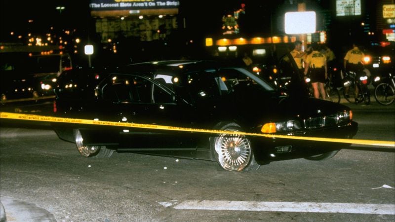 The bullet-riddled BMW in which rapper Tupac Shakur was fatally shot is pictured behind crime scene tape Sept. 7, 1996, at the scene in Las Vegas. Shakur, 25, died six days later, on Sept. 13, from his wounds. His killing has never been solved.