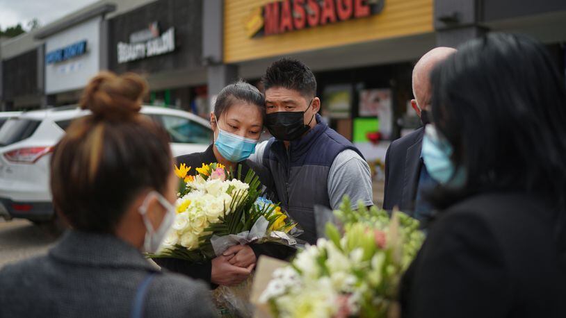 Jami Webb, the daughter of Xiaojie Tan, the owner of Young's Asian Massage who was killed in Tuesday's shootings, with her fiancé, Kevin Chen, outside the spa in Acworth, Ga., March 19, 2021. Tan died two days ahead of her 50th birthday. (Chang W. Lee/The New York Times)