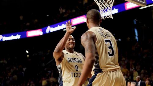 Georgia Tech's Charles Mitchell, left, high-fives teammate Marcus Georges-Hunt in the second half of an NCAA college basketball game against Georgia, Friday, Nov. 14, 2014, in Atlanta. (AP Photo/David Goldman)