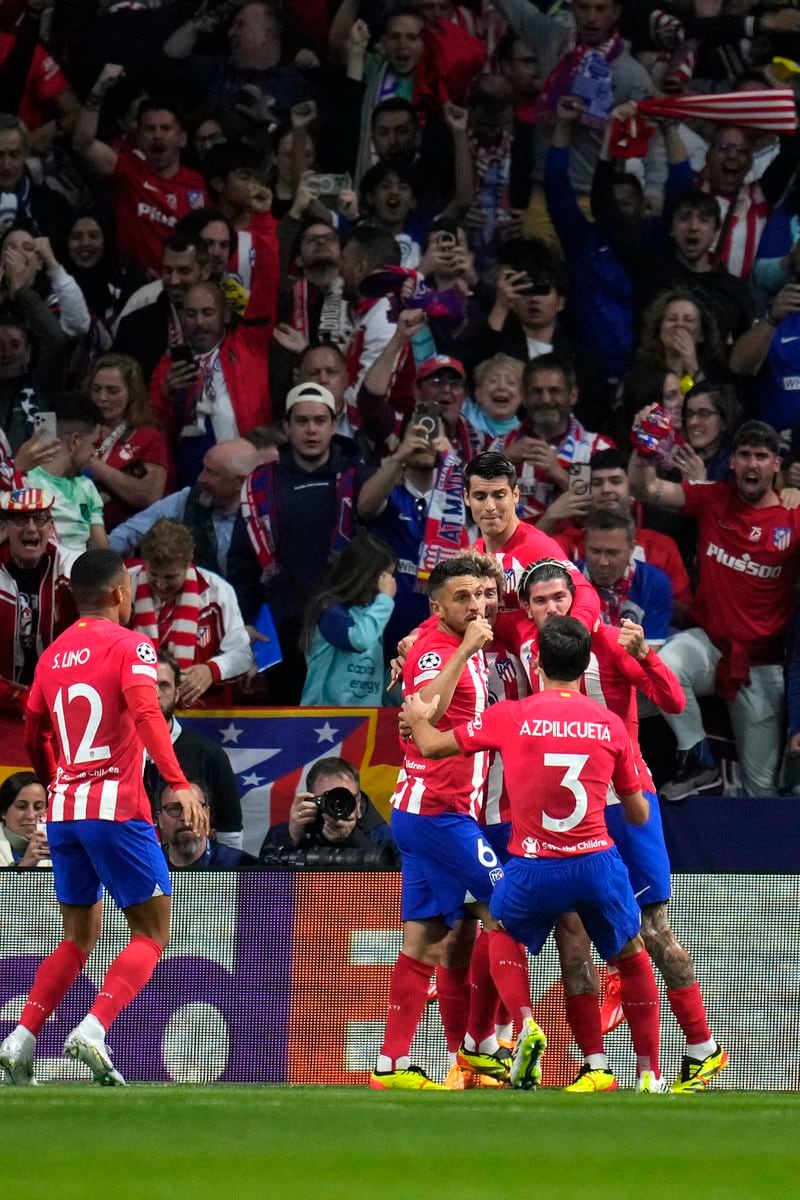 Atletico Madrid players celebrate after Atletico Madrid's Rodrigo De Paul scored his side's opening goal during the Champions League quarterfinal soccer match between Atletico Madrid and Borussia Dortmund at the Metropolitano stadium in Madrid, Spain, Wednesday, April 10, 2024. (AP Photo/Manu Fernandez)