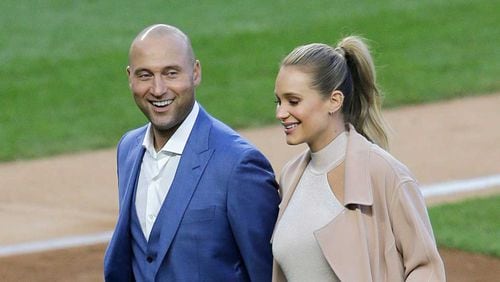 Derek Jeter and wife Hannah walk off the field at Yankee Stadium Sunday after the ceremony retiring Jeter's Yankee No. 2.