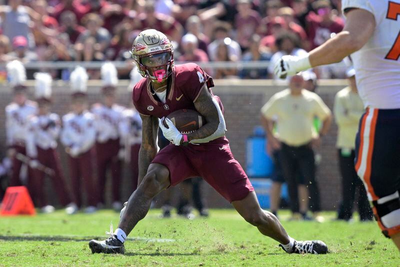 FILE - Florida State's Keon Coleman (4) runs on a punt return against Syracuse during the first half of an NCAA college football game Oct. 14, 2023, in Tallahassee, Fla. The Buffalo Bills elected not to trade back in the NFL draft order for a third time, and addressed their most significant need by selecting receiver Keon Coleman to open the second round Friday, April 26, 2024. (AP Photo/Phelan M. Ebenhack, File)