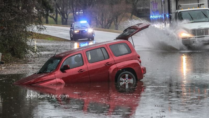 An SUV became stuck in standing water on the Jonesboro Road exit to I-285 near Forest Park on Monday morning.