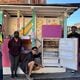 Members of the community volunteer to stock the Macon Community Fridge. The fridge started in 2020 due to food insecurities caused by COVID-19. (Photo Courtesy of Macon Community Fridge)