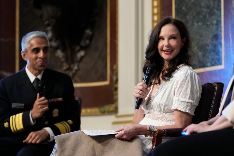 Ashley Judd, right, sitting with Surgeon General Dr. Vivek Murthy, left, speaks during an event on the White House complex in Washington, Tuesday, April 23, 2024, with notable suicide prevention advocates. The White House held the event on the day they released the 2024 National Strategy for Suicide Prevention to highlight efforts to tackle the mental health crisis and beat the overdose crisis. (AP Photo/Susan Walsh)
