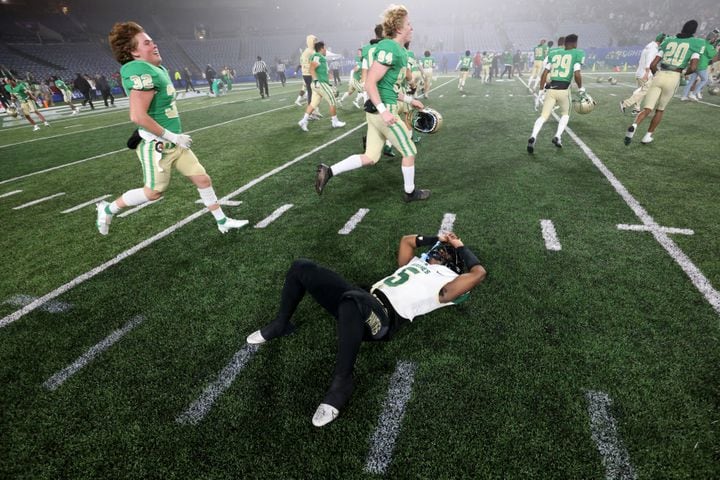 Langston Huges wide receiver Armani Tookes (5) reacts after their kicker missed the field goal as Buford players celebrate their 21-20 victory as time expires during the Class 6A state title football game at Georgia State Center Parc Stadium Friday, December 10, 2021, Atlanta. JASON GETZ FOR THE ATLANTA JOURNAL-CONSTITUTION
