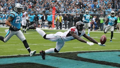 The Falcons offense continues to misfire with wide receiver Julio Jones just missing a Matt Ryan touchdown pass during the first half as Panthers safety Kurt Coleman defends in a NFL football game on Sunday, November 5, 2017, in Charlotte. Julio Jones also dropped a touchdown pass in the endzone during the second half in a 20-17 loss to the Panthers.   Curtis Compton/ccompton@ajc.com