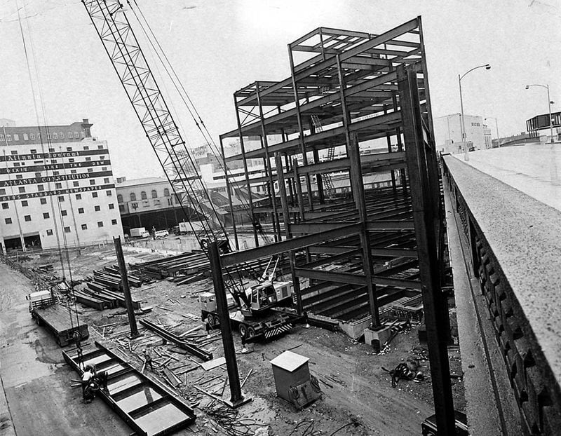 The girders go up in 1969 for a new production building along the Spring Street. (AJC file)