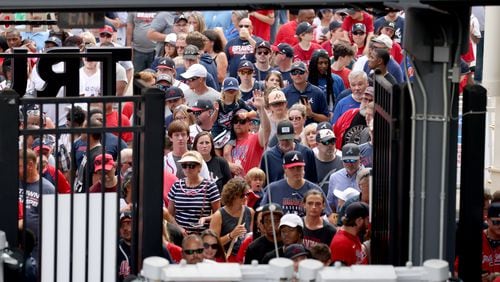 Braves fans line up to enter the right-field gate at Truist Park before the July 11 game against the New York Mets. (Jason Getz / Jason.Getz@ajc.com)