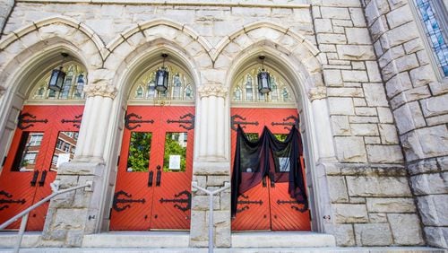 Saint Mark United Methodist Church on Peachtree Street has veiled one front door in respect of Good Friday on April 10, 2020. The veil also covers one of the posted messages that the church is closed until further notice. JENNI GIRTMAN / FOR THE AJC