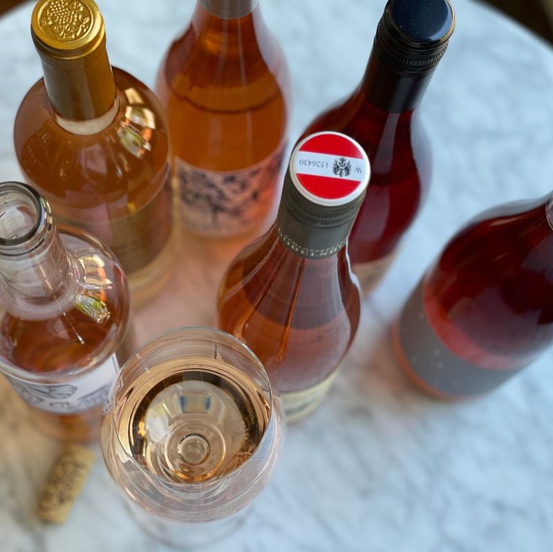 Rosé wine is made by allowing the juice of red grapes to briefly have contact with their skins; the intensity of color varies, based on grape type and the stylistic decisions of the winemaker. Krista Slater for The Atlanta Journal-Constitution