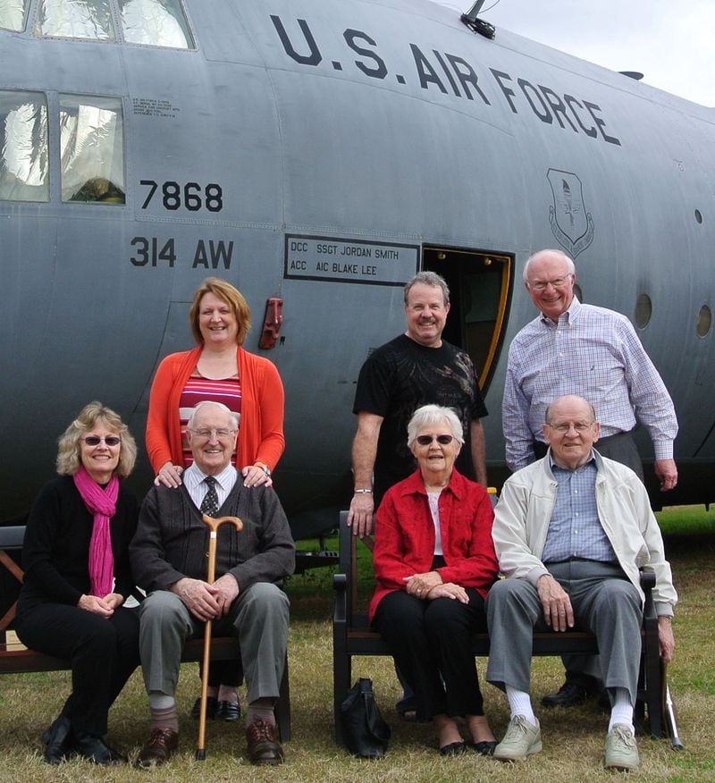 In this photo, Atlantan William "Mack" Secord (upper right) meets in 2013 with several of the Americans he flew to freedom during the rescue mission in the Congo. They are (from the left, seated): Marilyn Wendler, Bob McAllister, Jean Larson and Al Larson; (standing): Ruth (McAllister) Reynard and Larry Southard. They stand in front of the C-130 that Secord piloted during that 1964 operation. The aircraft is now parked at the Museum of Aviation in Warner Robins. CONTRIBUTED PHOTO