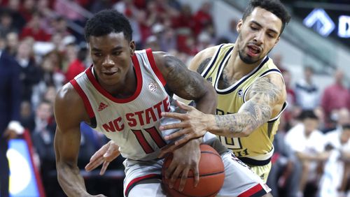 North Carolina State's Markell Johnson (11) drives around Georgia Tech's Jose Alvarado (10) during the first half Wednesday, March 6, 2019, in Raleigh, N.C.