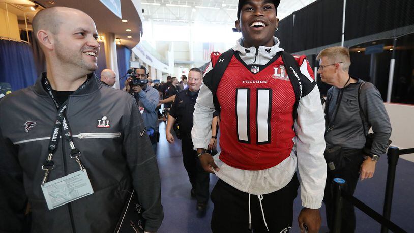 February 1, 2017, Houston: Falcons wide receiver Julio Jones shares a laugh with Brian Cearns, director of football communications, as they leave at the conclusion of Super Bowl media availability on Wednesday, Feb. 1, 2017, at the Memorial City Mall ice arena in Houston. Curtis Compton/ccompton@ajc.com