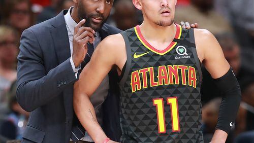 Hawks head coach Lloyd Pierce confers with Trae Young during a 123-110 victory over the Phoenix Suns in a NBA basketball game on Tuesday, January 14, 2020, in Atlanta.    Curtis Compton ccompton@ajc.com