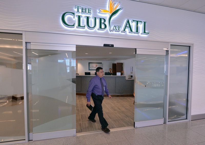 SECOND PHOTO!!! July 17, 2013 - Hapeville: Jorge Cortes walks walk through the doors at The Club at ATL, Hartsfield-Jackson International Airport's first independent VIP passenger lounge, on Wednesday, July 17, 2013. For a $35.00 day pass, passengers receive a shower, alcoholic beverages, snacks, internet access, newspapers and magazines. JOHNNY CRAWFORD / JCRAWFORD@AJC.COM