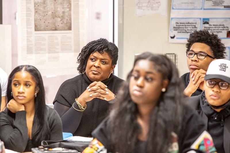 Atlanta Public Schools Superintendent Lisa Herring sits in on the Advanced Placement African American Studies class at Maynard Jackson High School on Friday, Feb 17, 2023.  Students participated in dialogue and debate and consider why restrictions are being put on the course in other states.  (Jenni Girtman for The Atlanta Journal-Constitution)