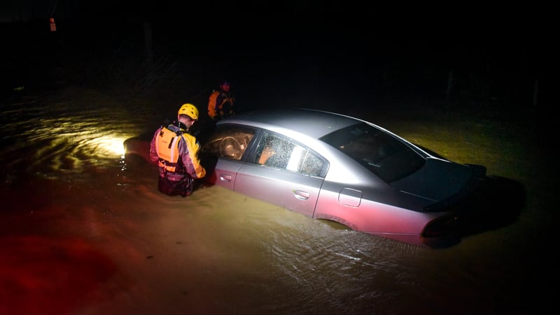 Rescue staff from the Municipal Emergency Management Agency investigate an empty flooded car during the passage of Hurricane Irma through the northeastern part of the island in Fajardo, Puerto Rico, Wednesday, Sept. 6, 2017. Hurricane Irma lashed Puerto Rico with heavy rain and powerful winds, leaving nearly 900,000 people without power as authorities struggled to get aid to small Caribbean islands already devastated by the historic storm. (AP Photo/Carlos Giusti)