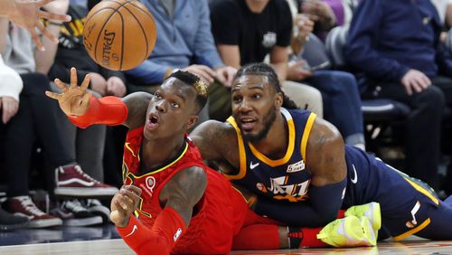 Hawks guard Dennis Schroder, left, passes the ball as Utah Jazz forward Jae Crowder, right, defends in the second half during an NBA basketball game Tuesday, March 20, 2018, in Salt Lake City. (AP Photo/Rick Bowmer)
