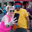 Paige Mack, left, takes a photo with Raghava “RJ” Jalaparthi following Big Peach Running Co. Alpharetta’s Wednesday night group run March 20, 2024. The run had a special ’80’s theme. Mack works for Big Peach and Jalaparthi is an Atlanta Track Club ambassador.  (Ben Gray / Ben@BenGray.com)