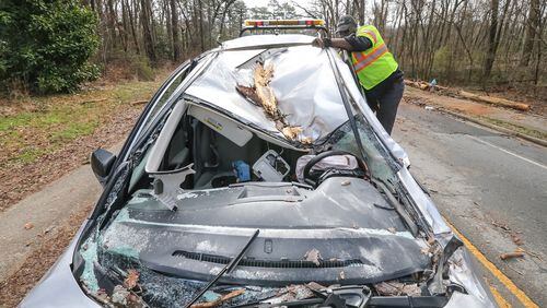 A tree fell on a DeKalb woman’s car and killed her Friday, March 3, 2016. JOHN SPINK/JSPINK@AJC.COM
