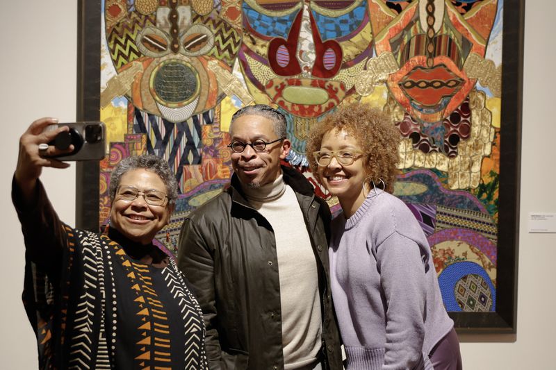 Photographer Susan “Sue” Ross takes a selfie with art collector Kent Kelley and Spelman Museum of Fine Art curator-in-residence Karen Comer Lowe during the VIP reception for the museum’s latest exhibition “Threaded” on Thursday, Feb. 1, 2024. (Natrice Miller/ Natrice.miller@ajc.com)