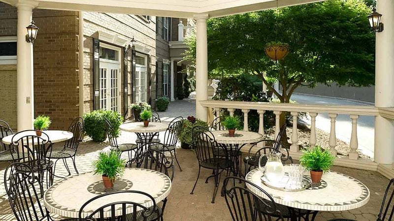 Atria Buckhead’s covered outdoor patio overlooks a fountain and garden trellis for a soothing dining experience.