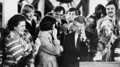 Jimmy and Rosalynn Carter wipe away tears at their greeting in Plains after winning the presidential election on Nov. 6, 1976. (Billy Downs / AJC file)