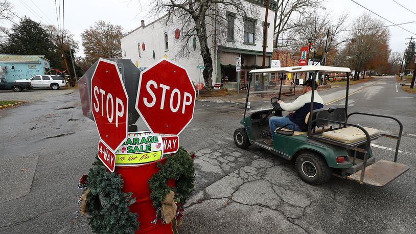 120821 Rutledge: A local resident navigates the 4-way stop on East Main Street in historic downtown Rutledge on his way to the Caboose on Wednesday, Dec 8, 2021. Ed Hogan, owner of the Caboose restaurant, is opposed to the Rivian GA electric vehicle plant saying "it's going to be too many vehicles. There will be 200 cars out here. I don't know what other people want but we like it the way it is" .   “Curtis Compton / Curtis.Compton@ajc.com”`