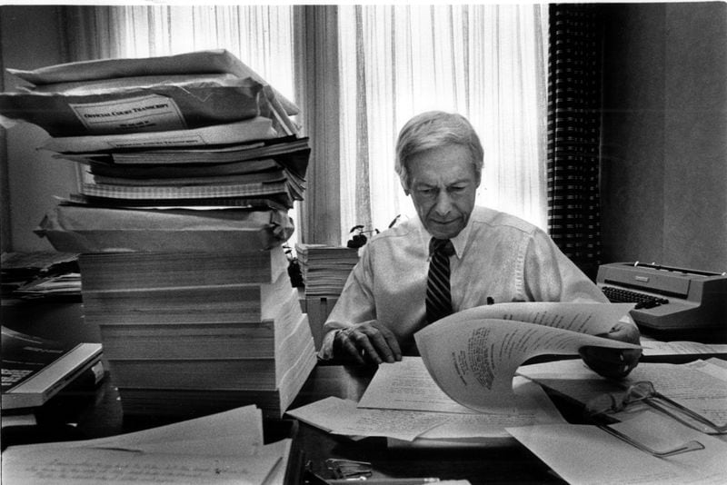 U. S. District Judge Marvin Shoob looks over a case in this 1985 file image. The large pile is one case.