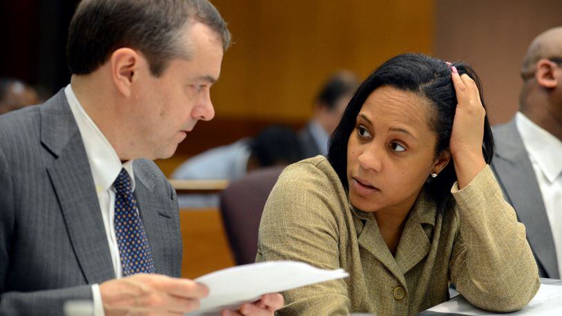 In this file photo, then-Fulton County assistant district attorneys John Floyd and Fani Willis confer as the judge considers the racketeering indictment June 18, 2013, in the Atlanta Public Schools test cheating case. (Photo: Kent D. Johnson/AJC)