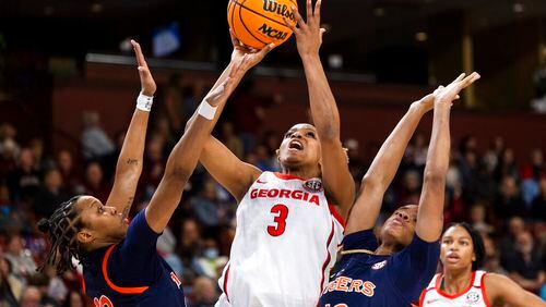 Georgia's Diamond Battles (3) shoots against Auburn's Honesty Scott-Grayson (23) and Mar'shaun Bostic (12) in the first half of an NCAA college basketball game in the Southeastern Conference women's tournament in Greenville, S.C., Thursday, March 2, 2023. (AP Photo/Mic Smith)