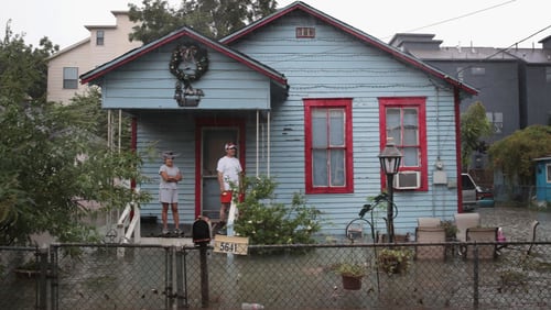 HOUSTON, TX - AUGUST 27:  People on a porch watch as rain from Hurricane Harvey inundates the Cottage Grove neighborhood on August 27, 2017 in Houston, Texas. Harvey, which made landfall north of Corpus Christi late Friday evening, is expected to dump upwards to 40 inches of rain in Texas over the next couple of days.  (Photo by Scott Olson/Getty Images)