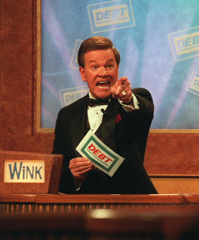 Host Wink Martindale indicates a correct answer to a contestant during the taping of the television game show 'Debt,' in Los Angeles May 22, 1997.(AP Photo/Nick Ut)