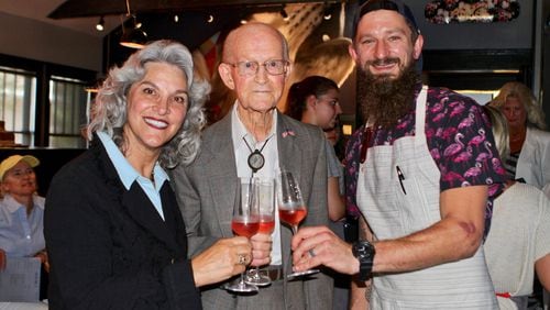 Cheri Morris, the developer of the new Alpharetta City Center, George Jones and chef Taylor Neary toast opening night of Restaurant Holmes in Alpharetta. Jones, 97, grew up in the bungalow turned restaurant. CONTRIBUTED BY DIANE MAICON