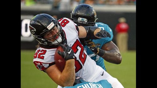 Atlanta Falcons' Logan Paulsen (82) is stopped by Jacksonville Jaguars defensive tackle Malik Jackson, right, after a reception during the first half of an NFL preseason football game Saturday, Aug. 25, 2018, in Jacksonville, Fla. (AP Photo/Stephen B. Morton)