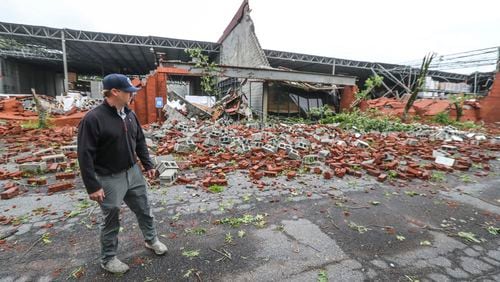 Dru Ghegan, President of Bonded Service Warehouse at 1805 Westgate Parkway, surveys the damage Tuesday nearly 24 hours after a possible tornado blew through the area of Fulton Industrial Boulevard.