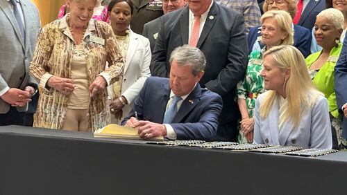 Georgia Gov. Brian Kemp signs the budget for the year beginning July 1, 2024 at the state capitol in Atlanta on Tuesday, May 7, 2024. Kemp says the document shows Georgia can boost spending and cut taxes at the same time. (AP Photo/Jeff Amy)