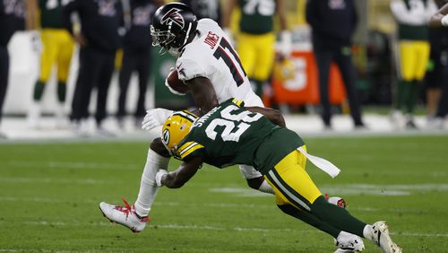 Julio Jones (11) is hit by Packers RB Darnell Savage (26) after a catch in the first half of Monday's Falcons-Packers game.