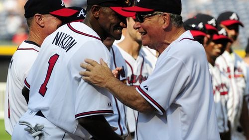 In this Aug. 13, 2011 file photo, former Atlanta Braves player Otis Nixon, left, is greeted by former Braves manager Bobby Cox during a Braves Legends Game. (Associated Press photo)