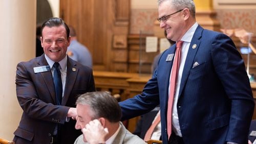 State Sen. Clint Dixon, R-Gwinnett, (right) shakes hands with Sen. Shawn Still, R-Norcross, (left) following the passage of Senate Bill 386, a sports betting bill, in the Senate at the Capitol in Atlanta on Feb. 1. Still is one of 19 people charged last August in the Georgia election interference case. (Arvin Temkar/arvin.temkar@ajc.com)